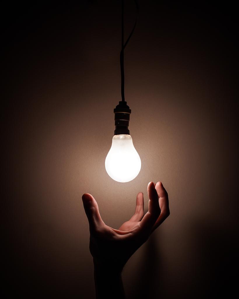 A light bulb and a hand