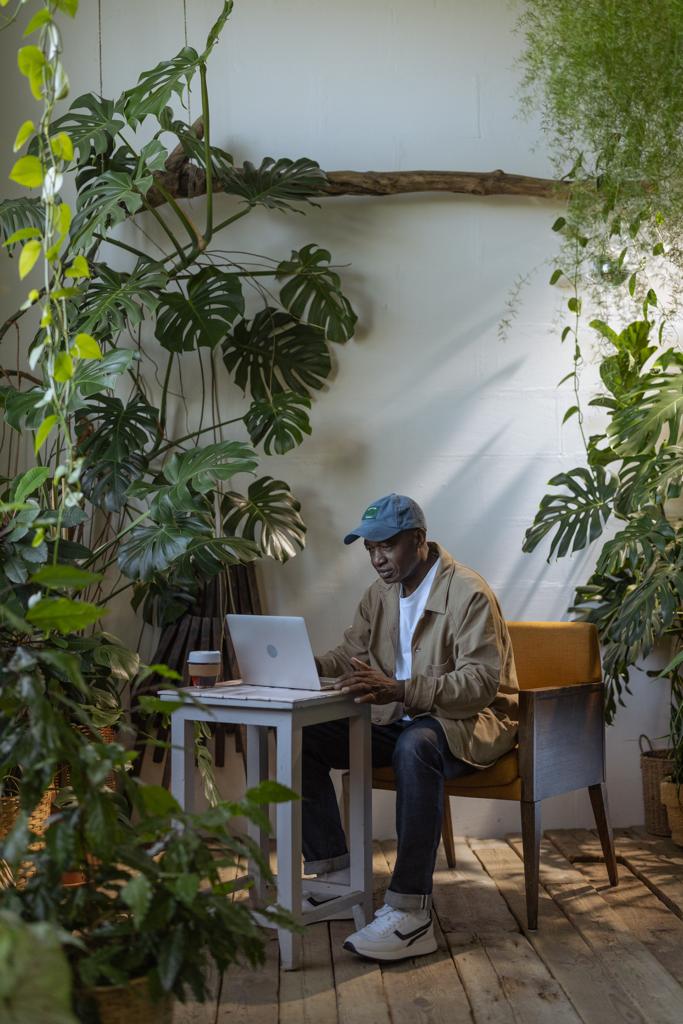 A man working on his laptop inside a garden